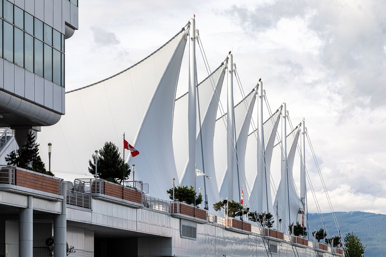 The five white sails of Canada Place against a blue sky